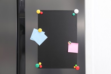 Photo of Magnetic board and notes on refrigerator in kitchen