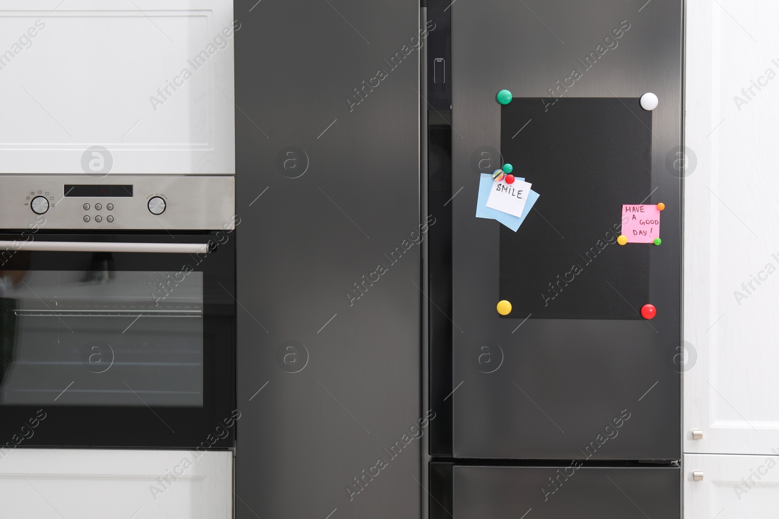 Photo of Magnetic board and notes on refrigerator in kitchen