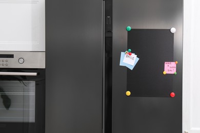 Photo of Magnetic board and notes on refrigerator in kitchen