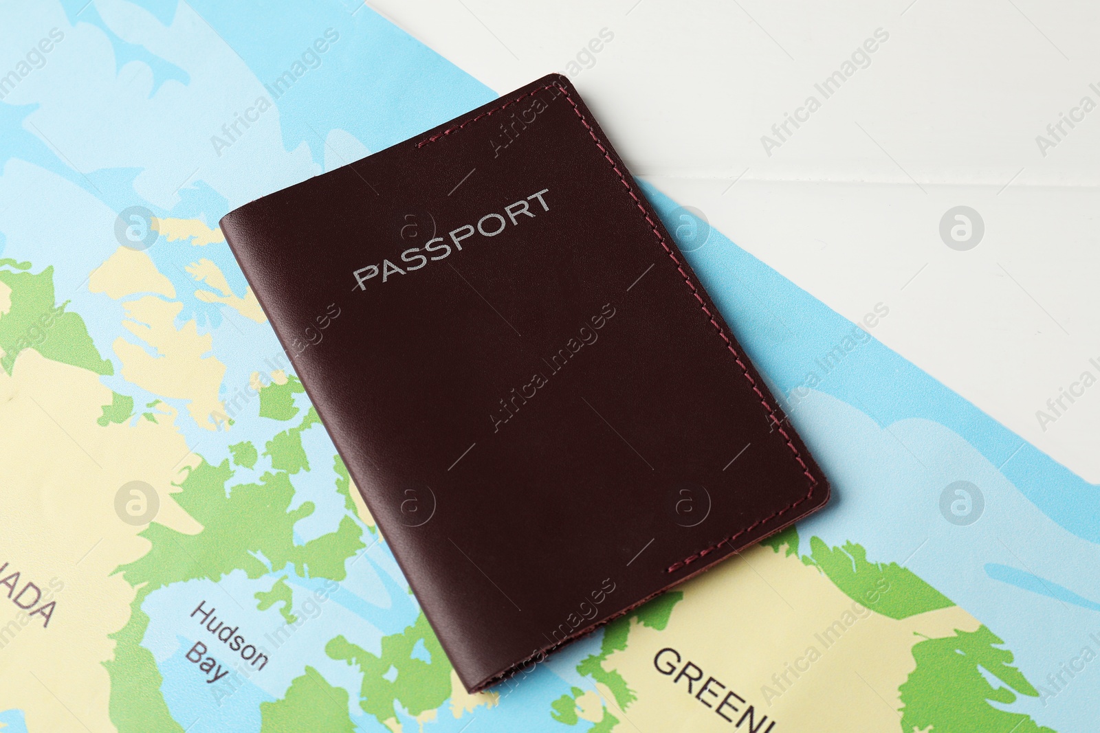 Photo of Passport and world map on white wooden table, flat lay