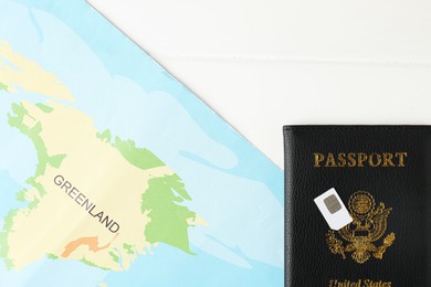 Photo of Passport, Sim card and world map on white wooden table, flat lay