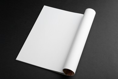 Photo of Open magazine with blank page on black background. Mockup for design