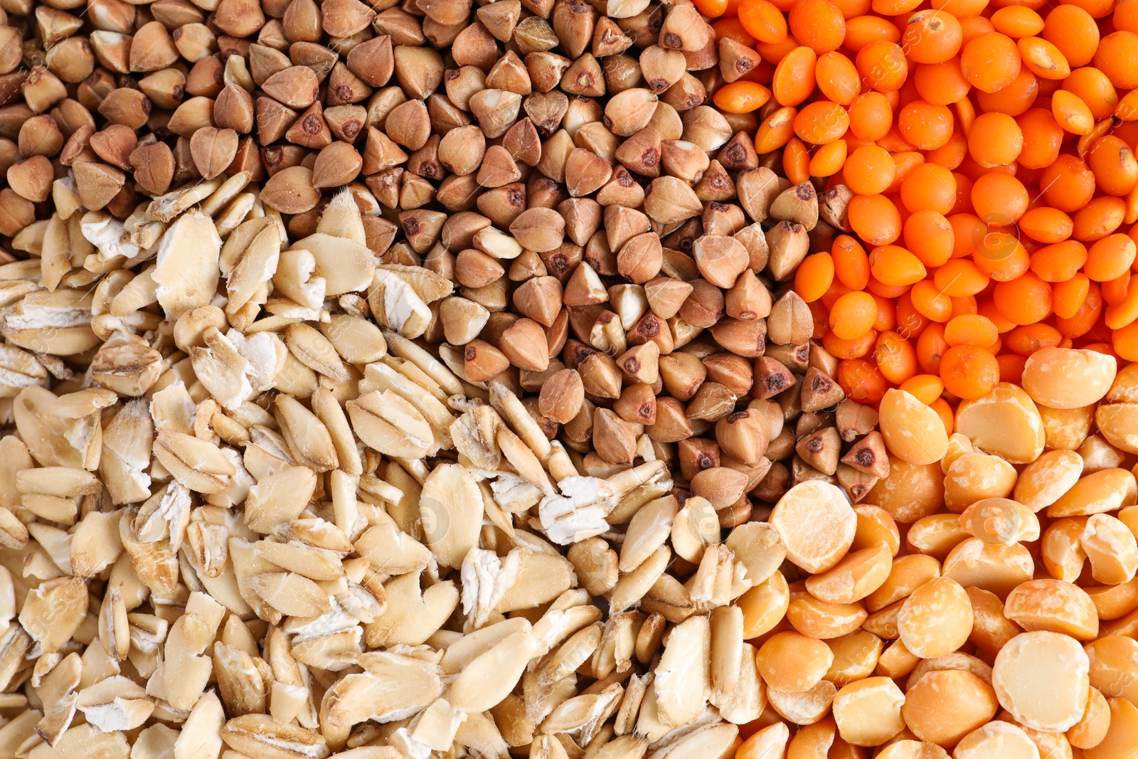 Photo of Different cereal grains as background, top view