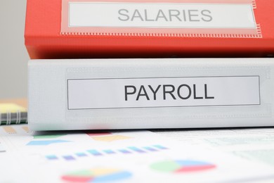 Photo of Payroll. Folders and charts on table, closeup