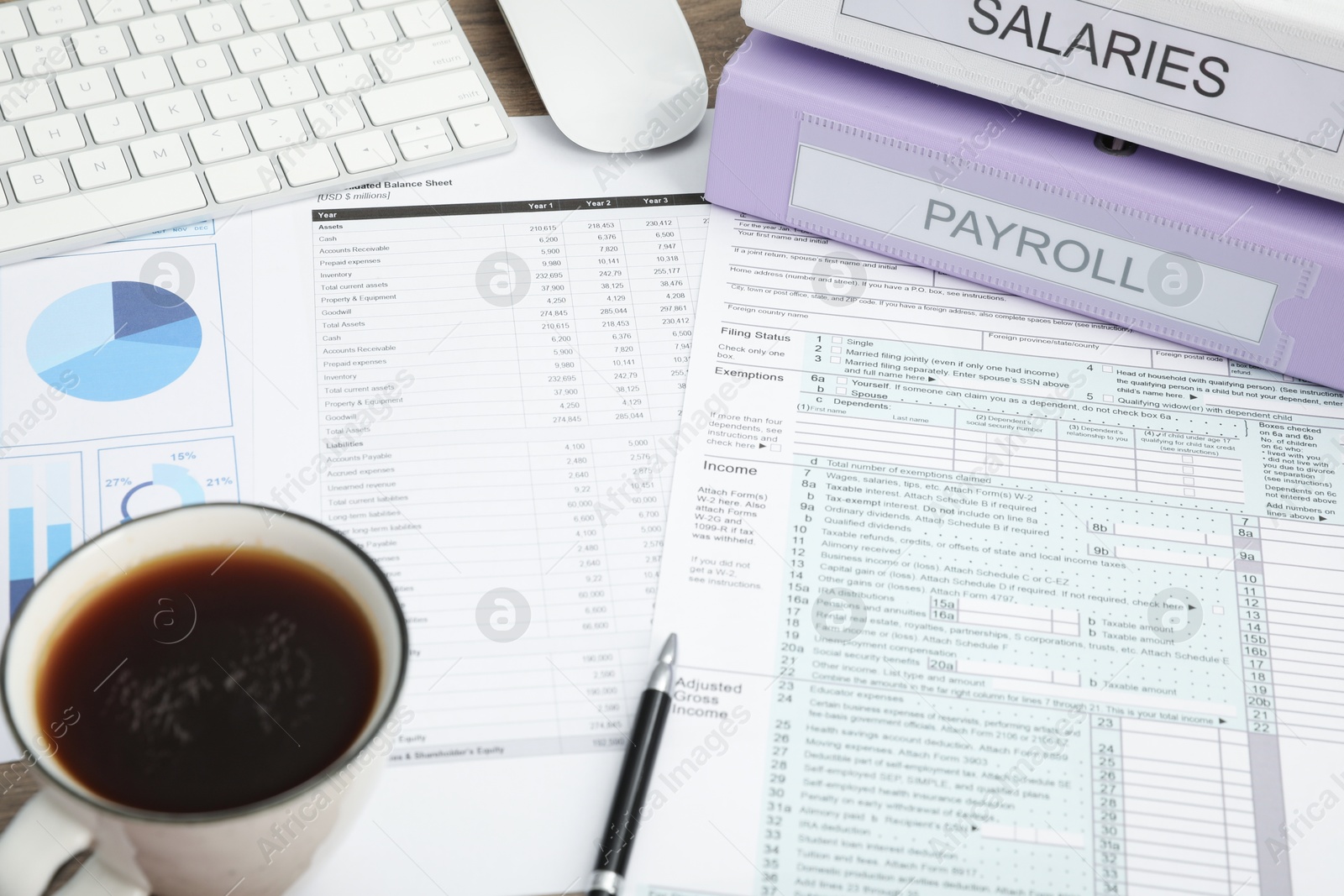 Photo of Payroll. Papers, pen and cup of coffee on table