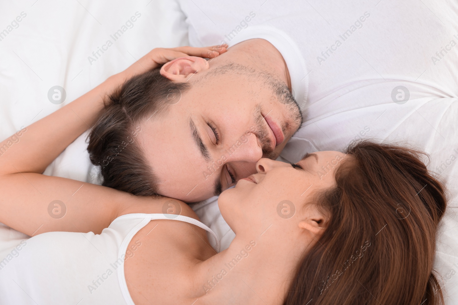 Photo of Cute couple spending time together on bed at home