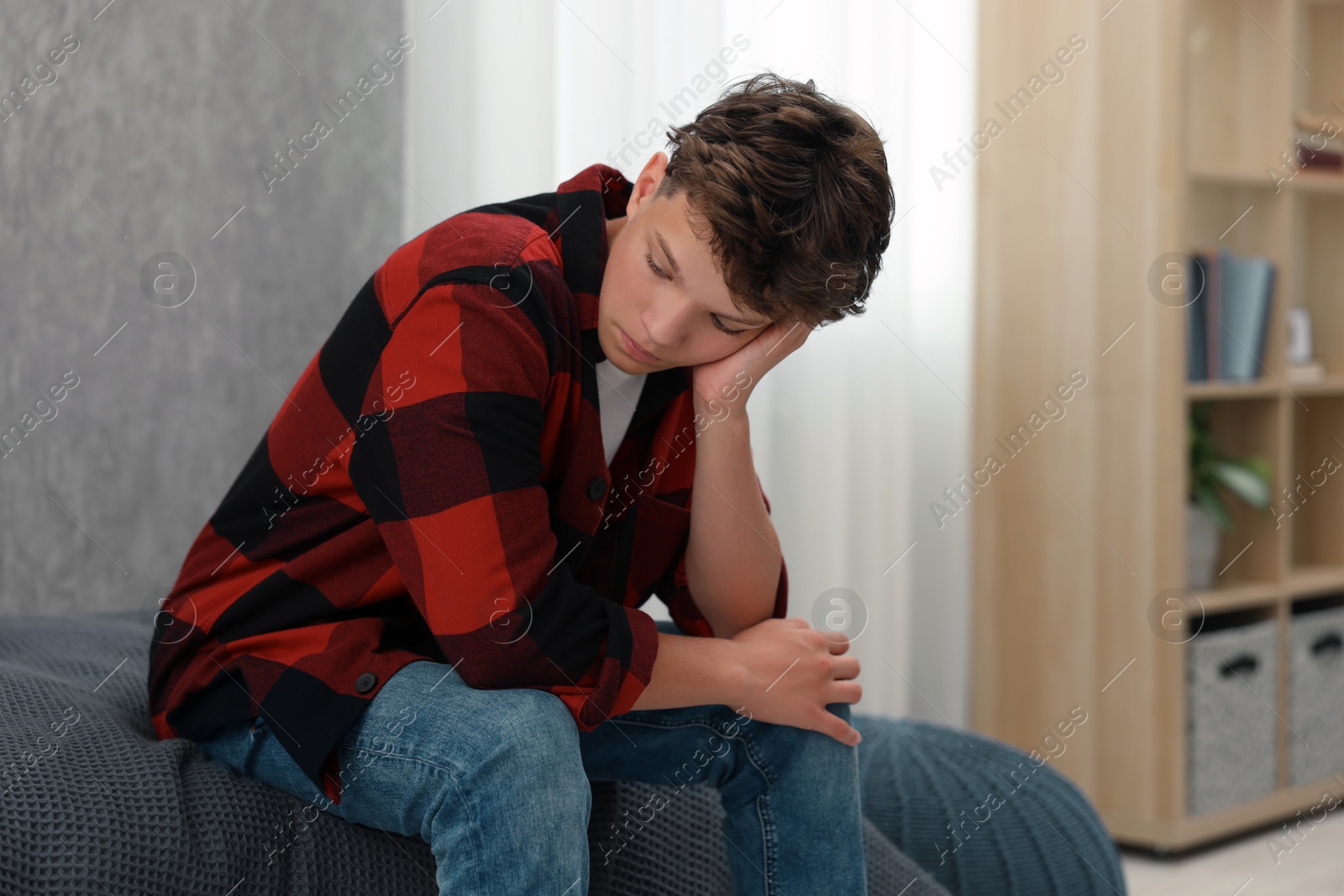 Photo of Loneliness concept. Sad teenage boy on bed at home