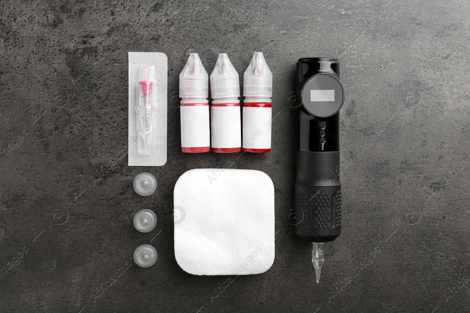 Photo of Permanent makeup equipment kit on grey table, flat lay