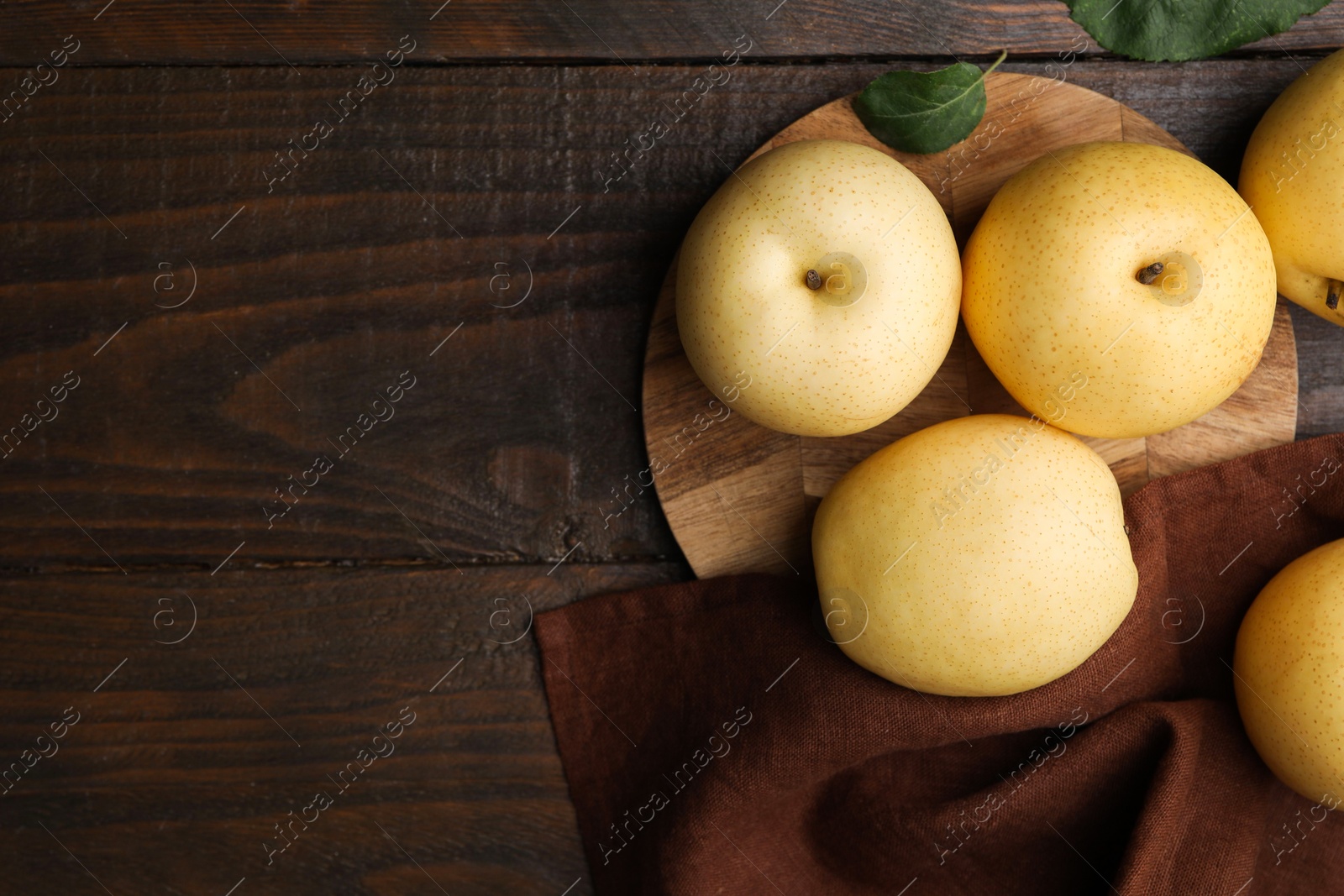 Photo of Delicious fresh apple pears on wooden table, top view. Space for text