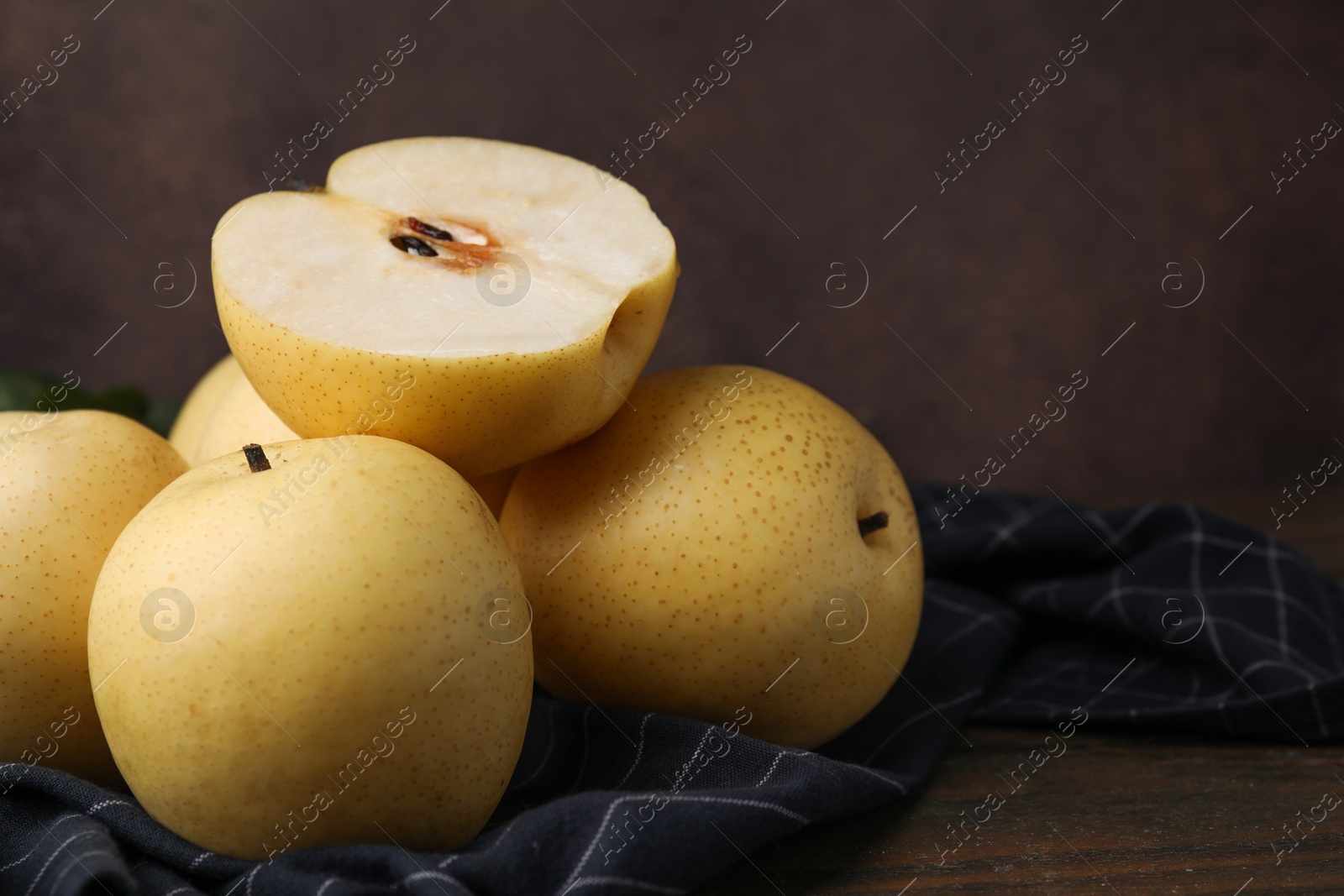 Photo of Delicious fresh apple pears on wooden table, closeup. Space for text