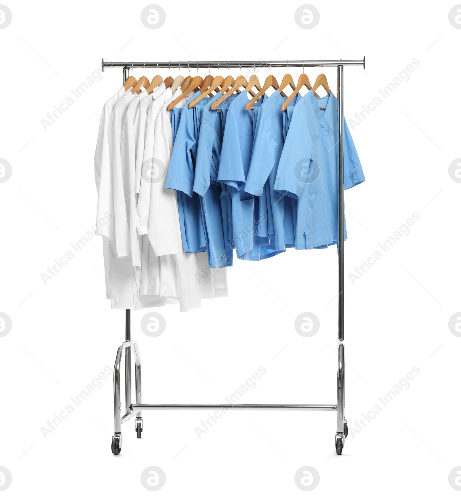 Photo of Different medical workers' uniforms on clothing rack against white background