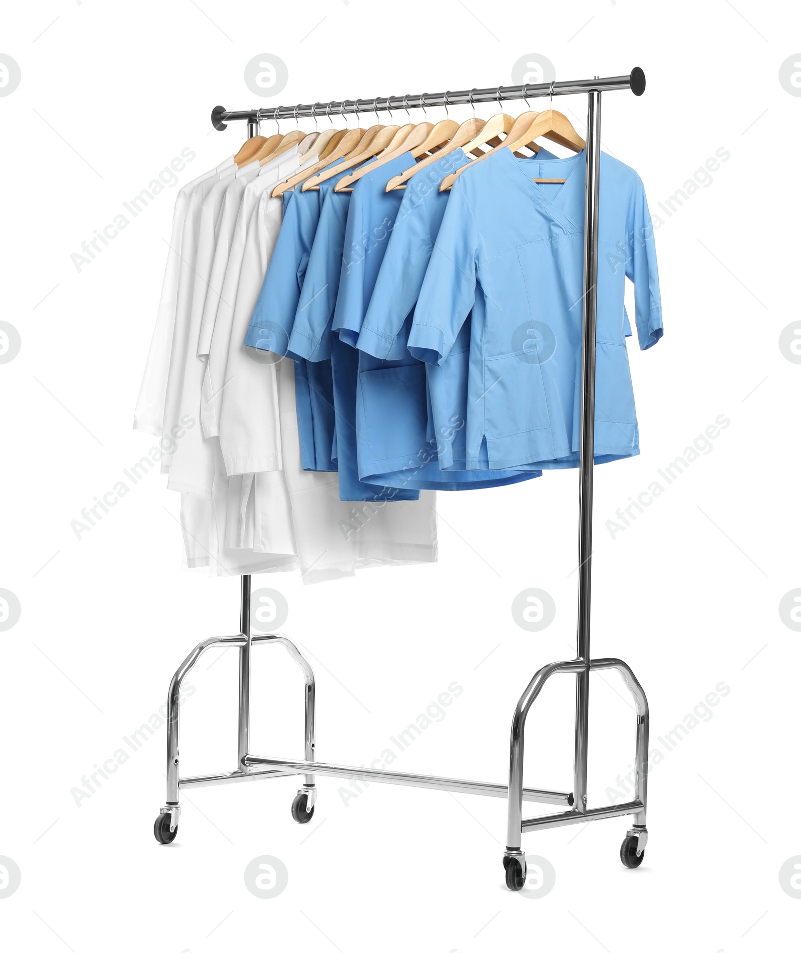 Photo of Different medical workers' uniforms on clothing rack against white background