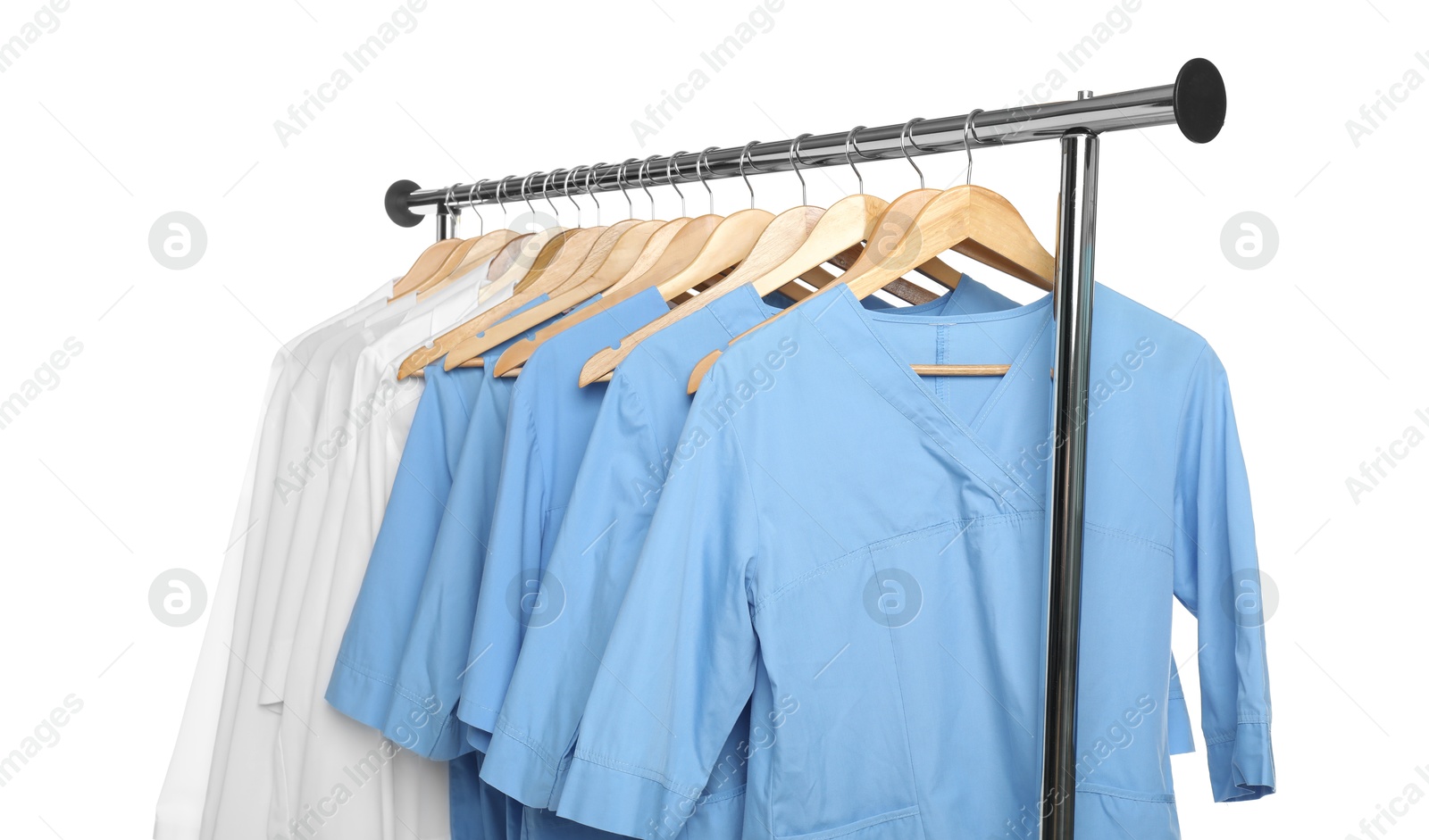 Photo of Different medical workers' uniforms on clothing rack against white background