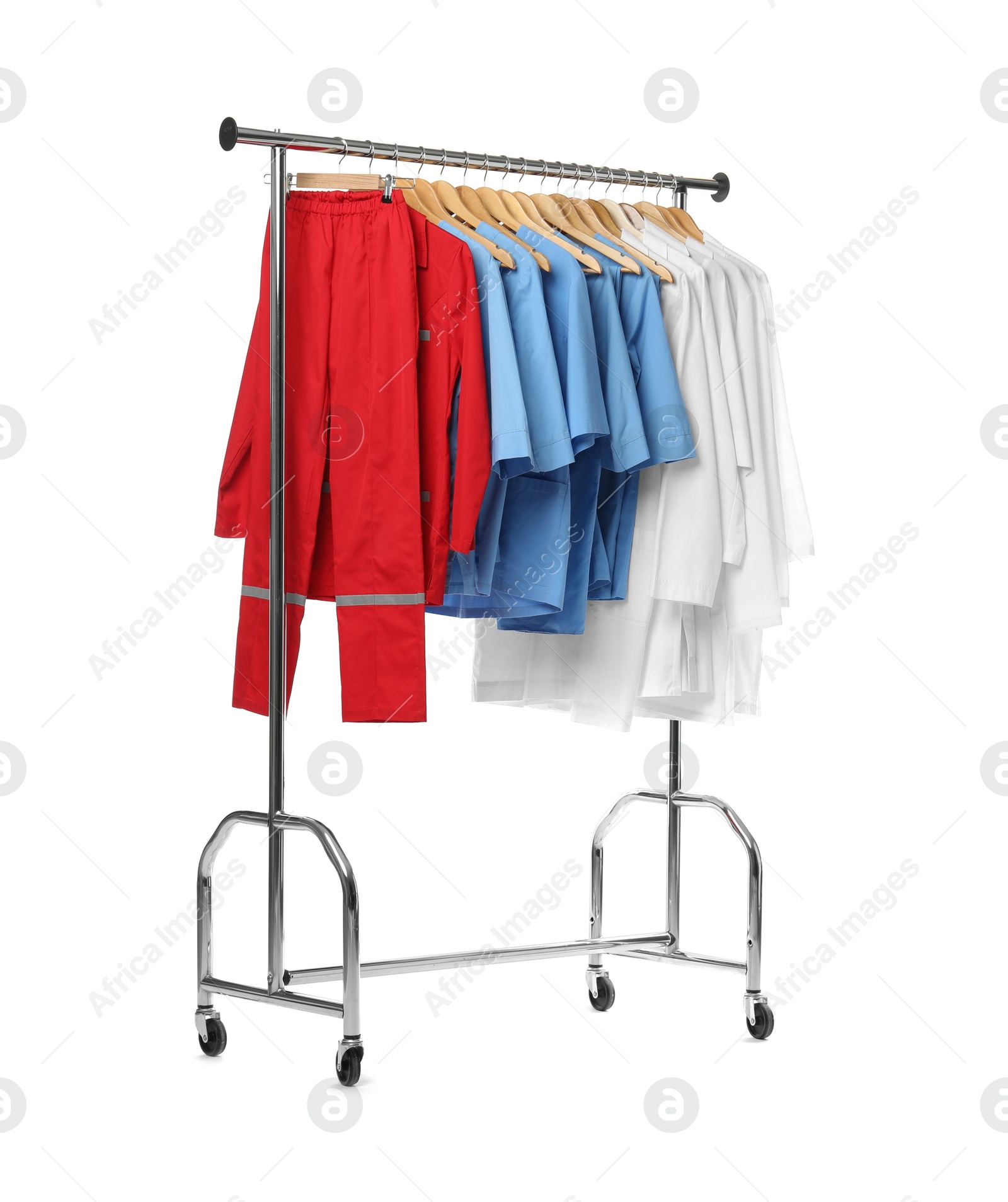 Photo of Different medical workers' uniforms on clothing rack against white background