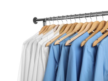 Photo of Different medical workers' uniforms on clothing rack against white background