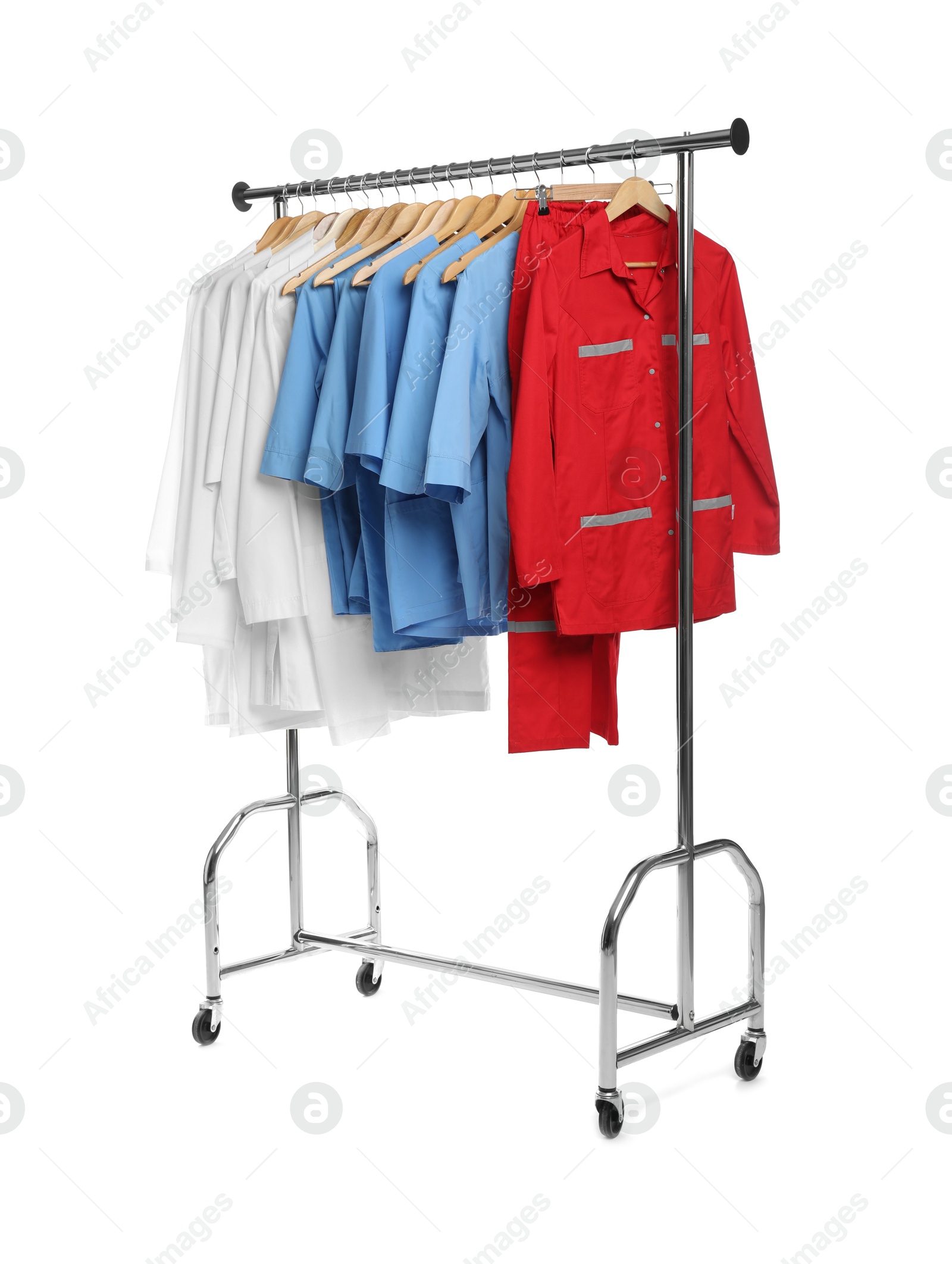 Photo of Different medical workers' uniforms on clothing rack against white background