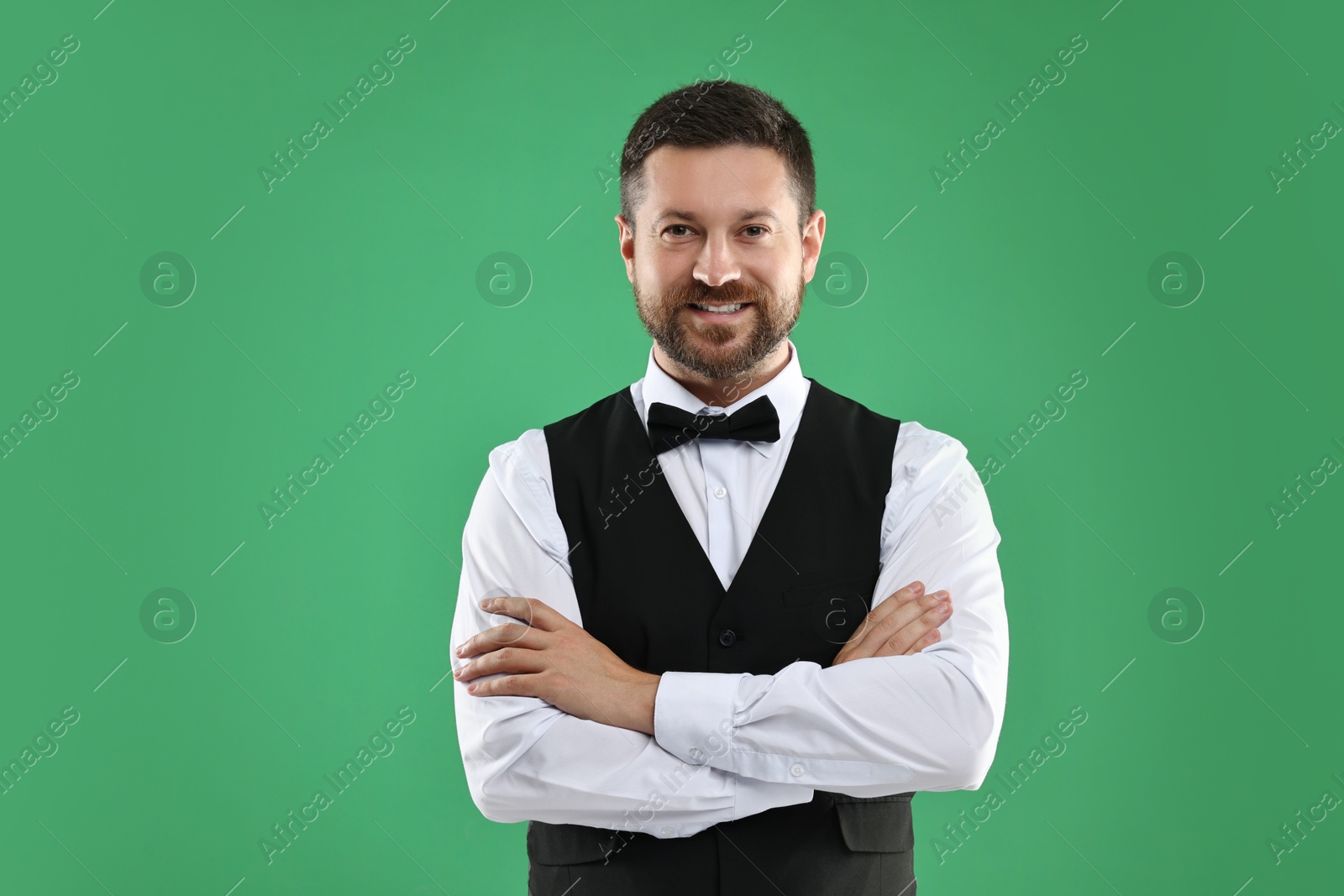 Photo of Portrait of professional croupier on green background