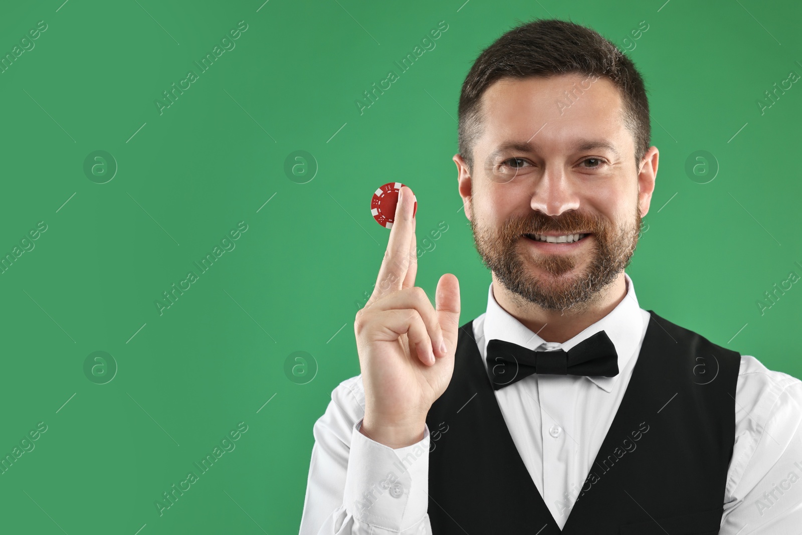 Photo of Croupier with casino chip on green background, space for text