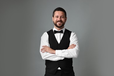 Photo of Portrait of professional croupier on grey background