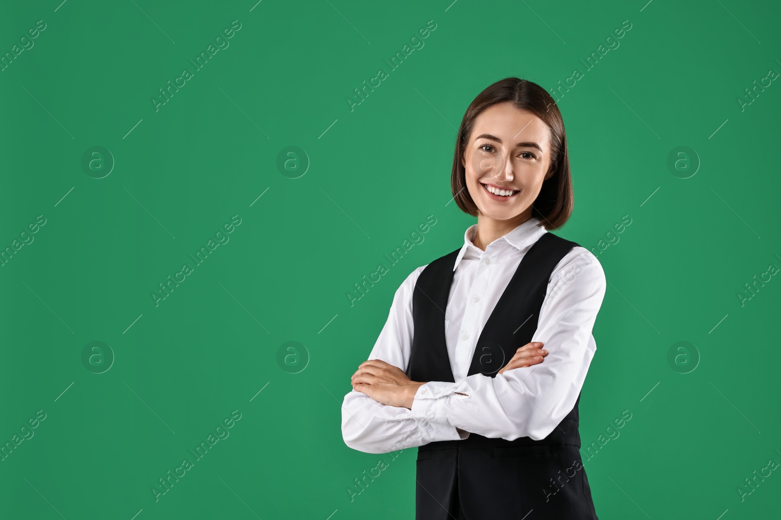 Photo of Portrait of professional croupier on green background. Space for text