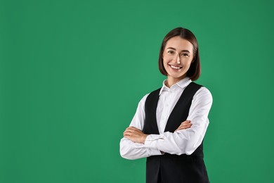 Photo of Portrait of professional croupier on green background. Space for text