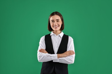 Portrait of professional croupier on green background