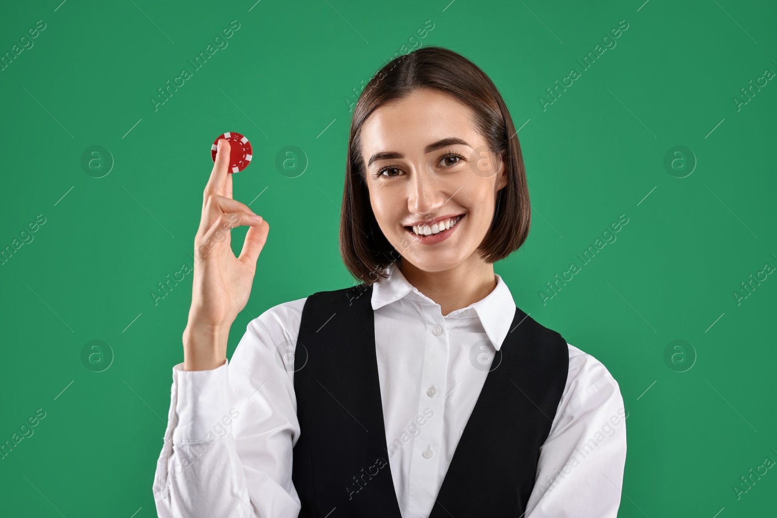 Photo of Croupier with casino chip on green background