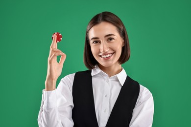 Photo of Croupier with casino chip on green background