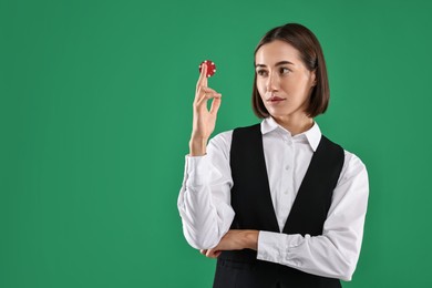 Photo of Croupier with casino chip on green background. Space for text