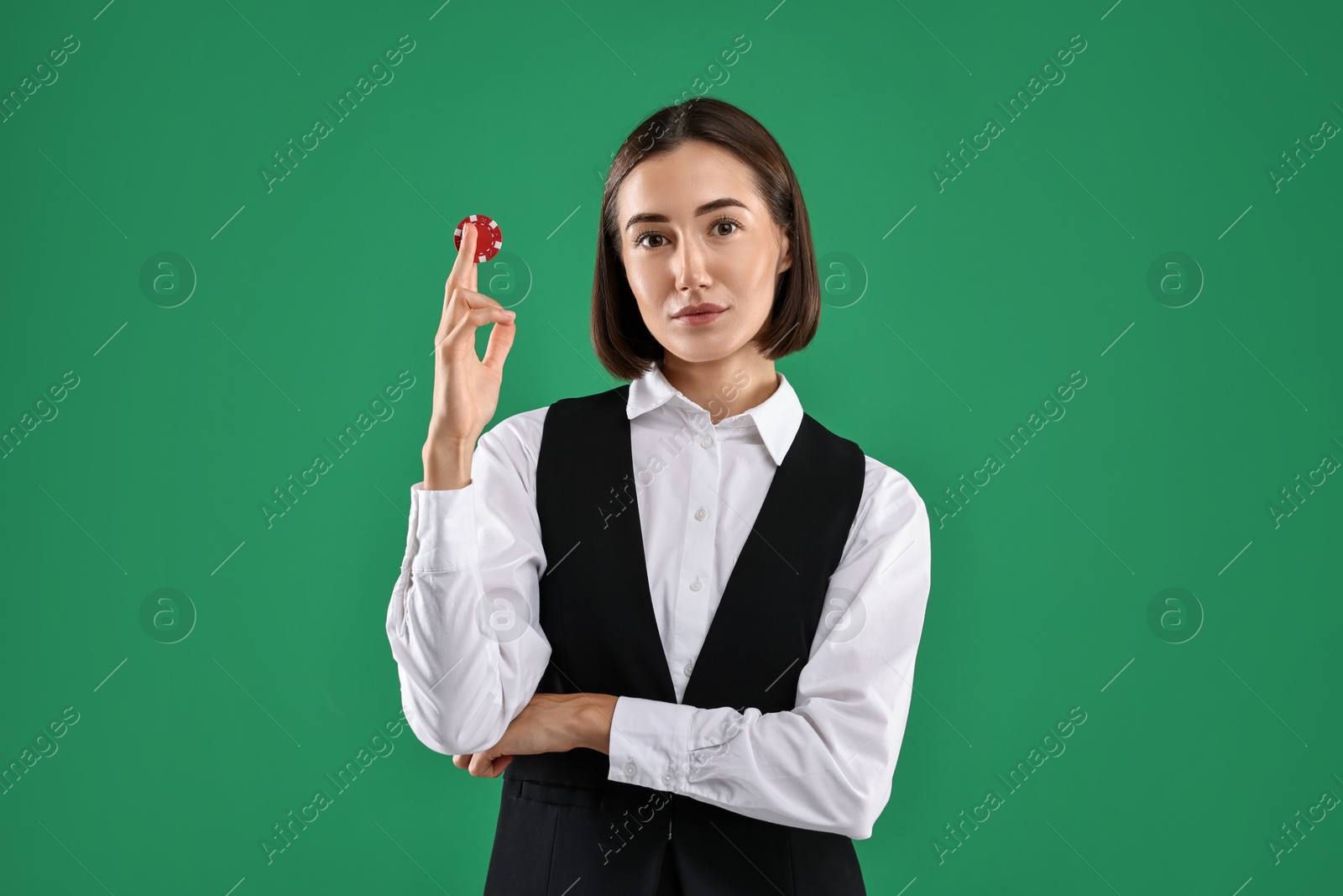 Photo of Croupier with casino chip on green background