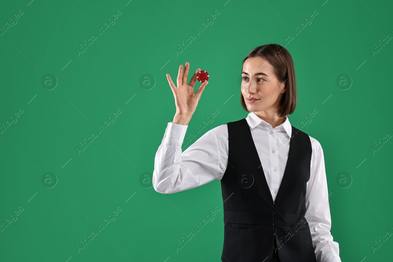 Photo of Croupier with casino chip on green background. Space for text