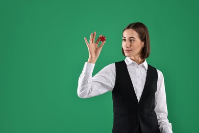 Croupier with casino chip on green background. Space for text