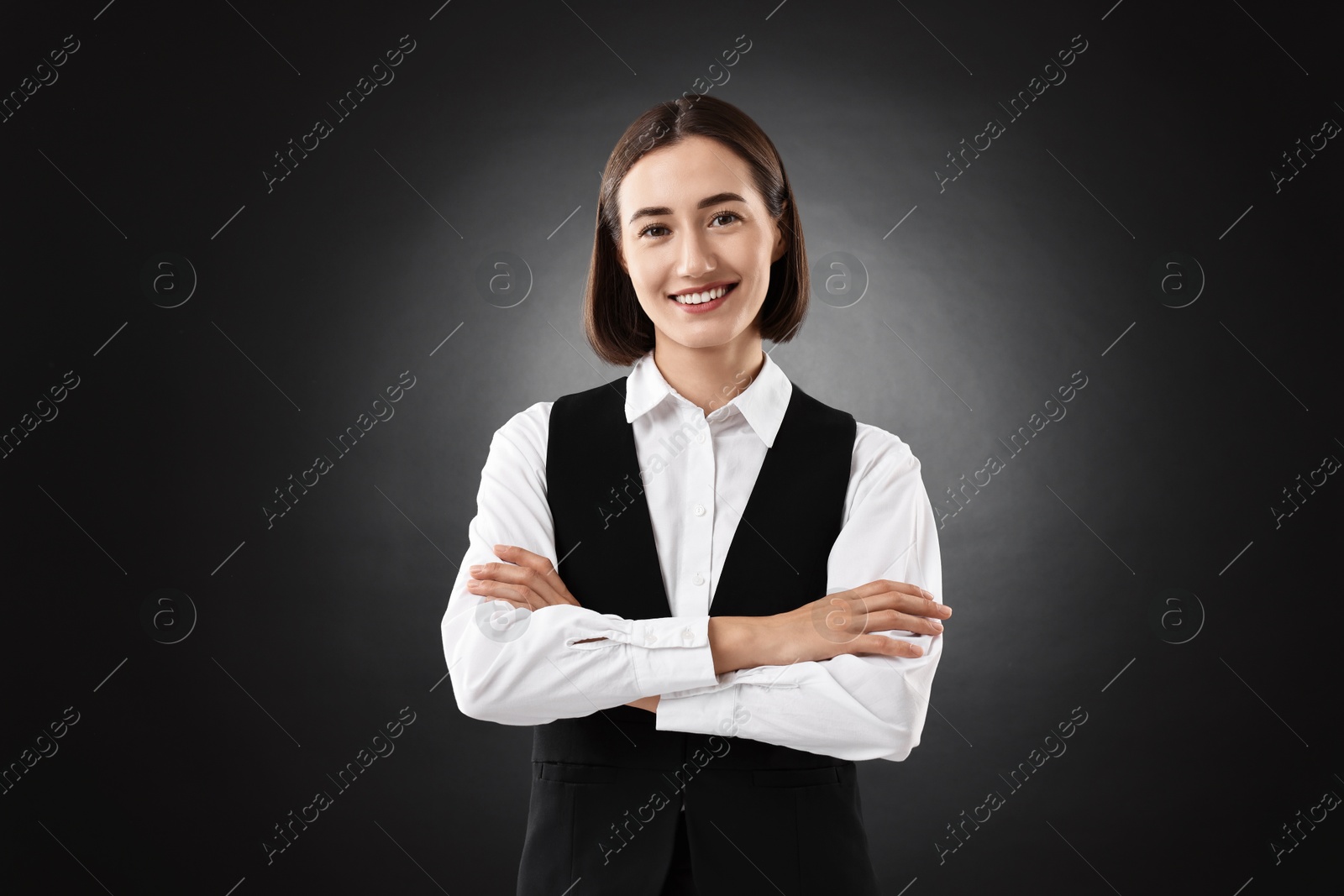 Photo of Portrait of professional croupier on black background