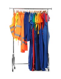 Different workers' uniforms on clothing rack isolated on white