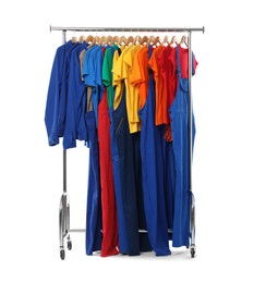 Photo of Different workers' uniforms on clothing rack isolated on white