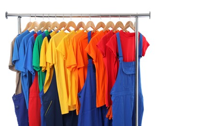 Different workers' uniforms on clothing rack on white background