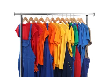 Photo of Different workers' uniforms on clothing rack isolated on white