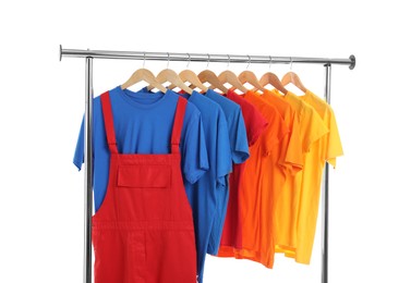 Photo of Worker's uniform and t-shirts on clothing rack isolated on white