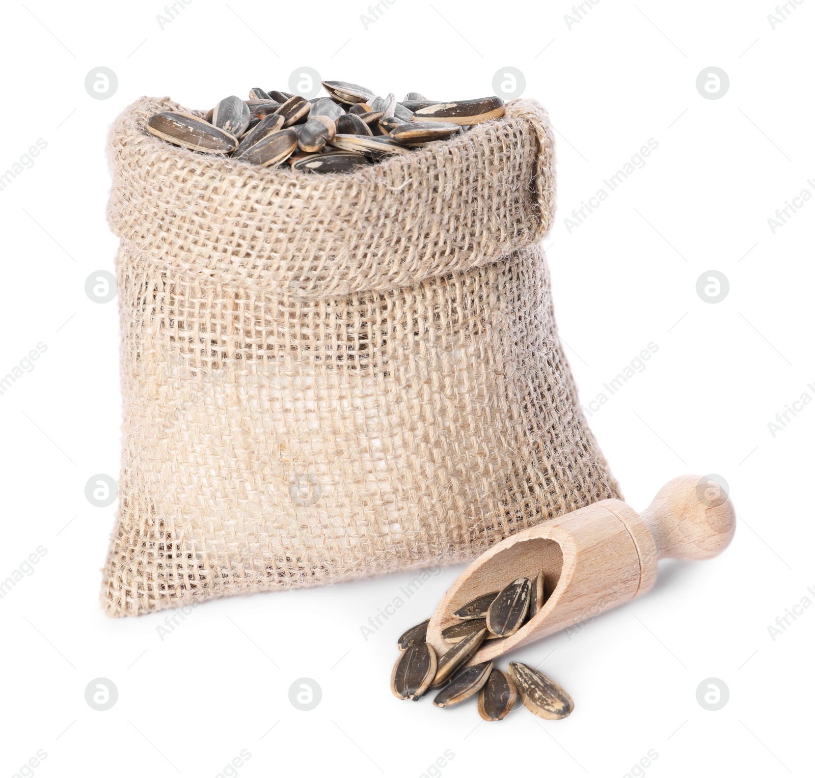 Photo of Burlap sack with sunflower seeds and scoop isolated on white