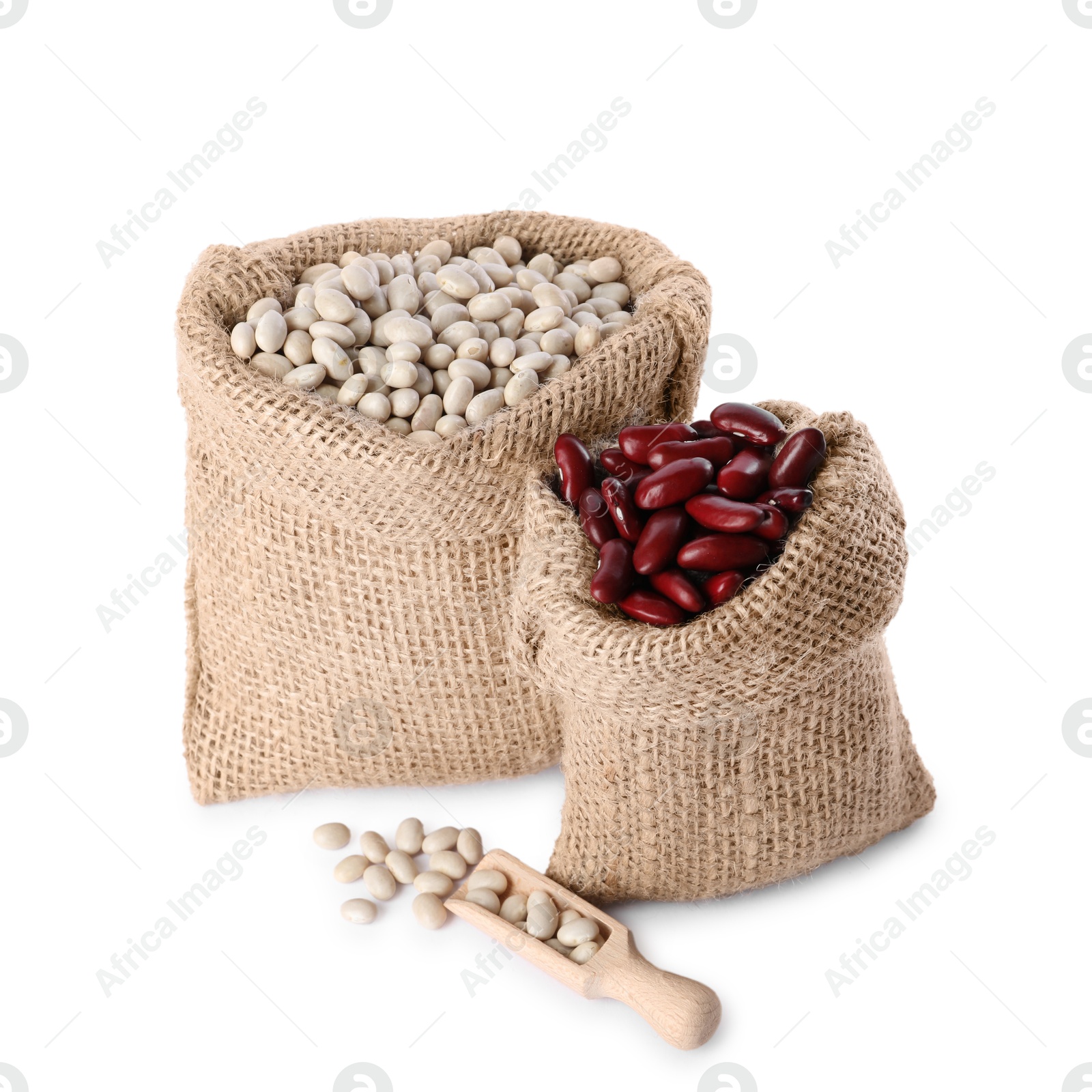 Photo of Burlap sacks with different dried beans and scoop isolated on white