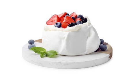 Photo of Pavlova cake (meringue dessert) with whipped cream, fresh berries and mint isolated on white