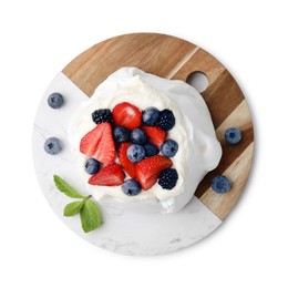 Photo of Pavlova cake (meringue dessert) with whipped cream, fresh berries and mint isolated on white, top view