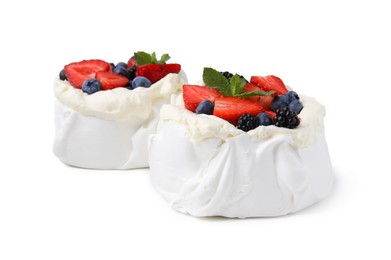 Photo of Pavlova cake (meringue dessert) with whipped cream, fresh berries and mint isolated on white