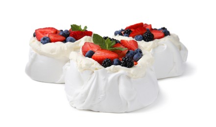 Photo of Pavlova cake (meringue dessert) with whipped cream, fresh berries and mint isolated on white