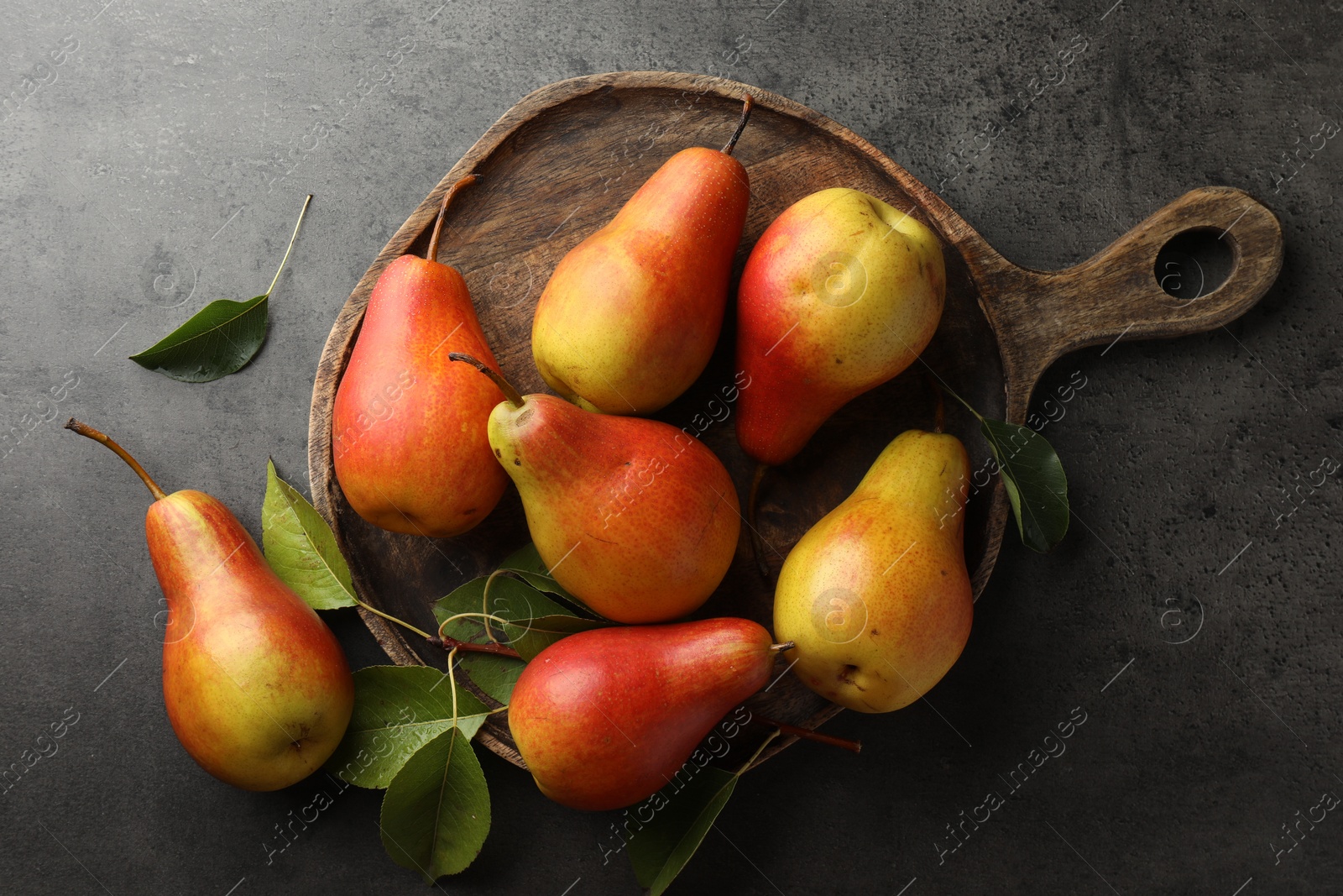 Photo of Ripe juicy pears on grey table, flat lay