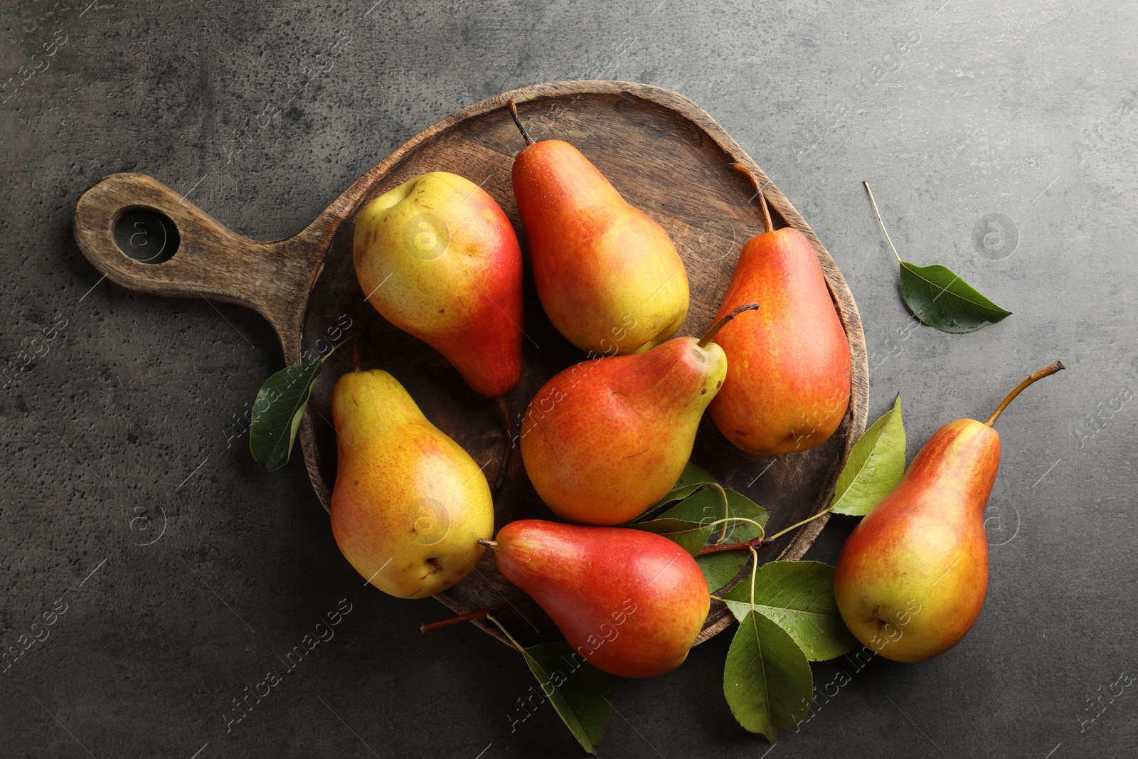 Photo of Ripe juicy pears on grey table, flat lay