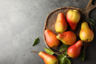 Photo of Ripe juicy pears on grey table, flat lay. Space for text