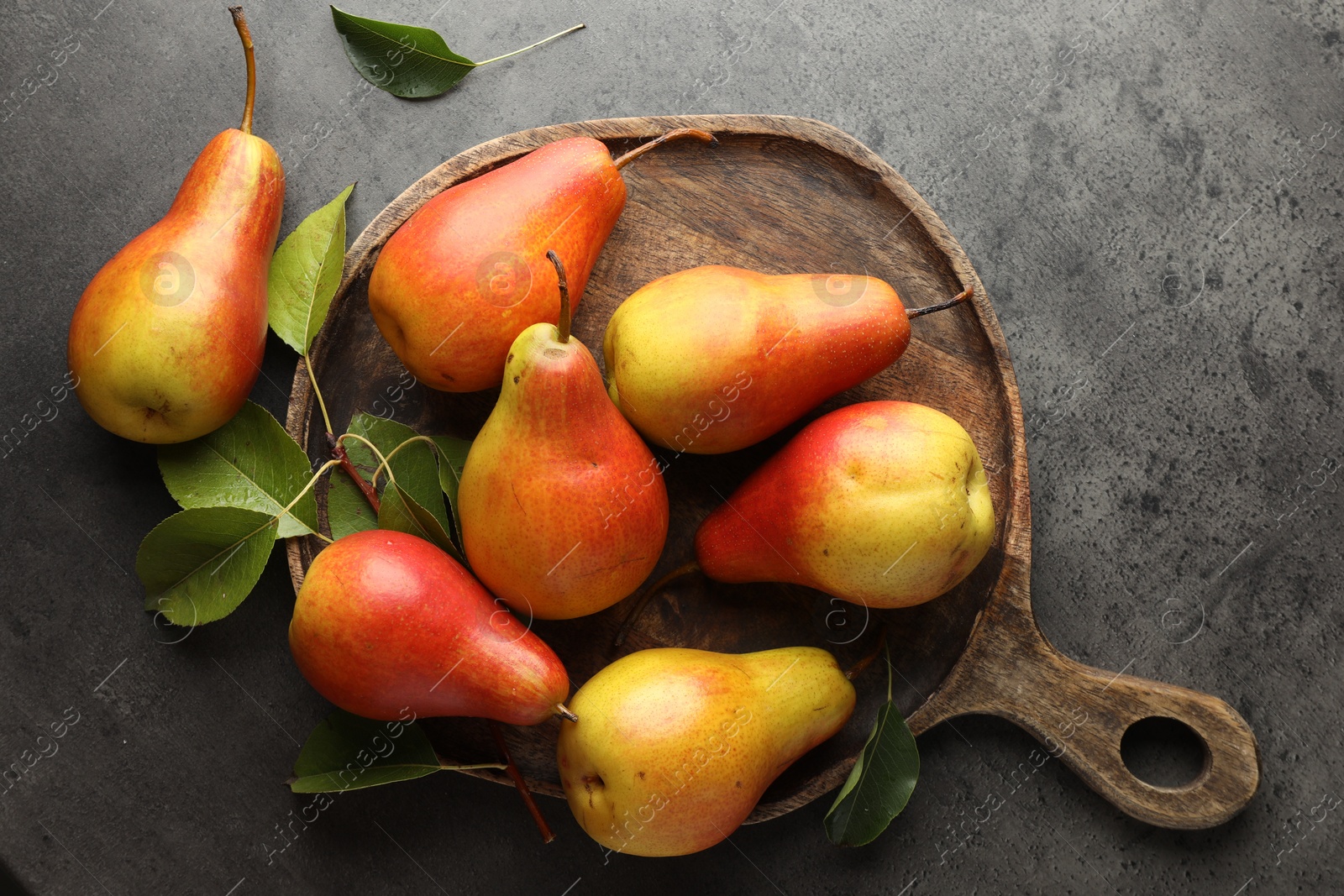 Photo of Ripe juicy pears on grey table, flat lay