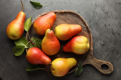 Photo of Ripe juicy pears on grey table, flat lay