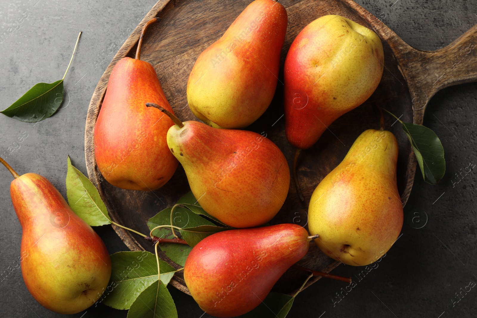 Photo of Ripe juicy pears on grey table, flat lay